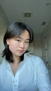 woman with black hair in white shirt